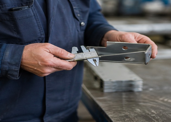 Sheet Metal Fabrication final review scene in a modern manufacturing workshop