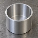 Machined metal cup showing its rim and interior wall