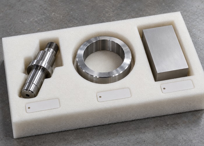 Machined steel components separated in protective foam