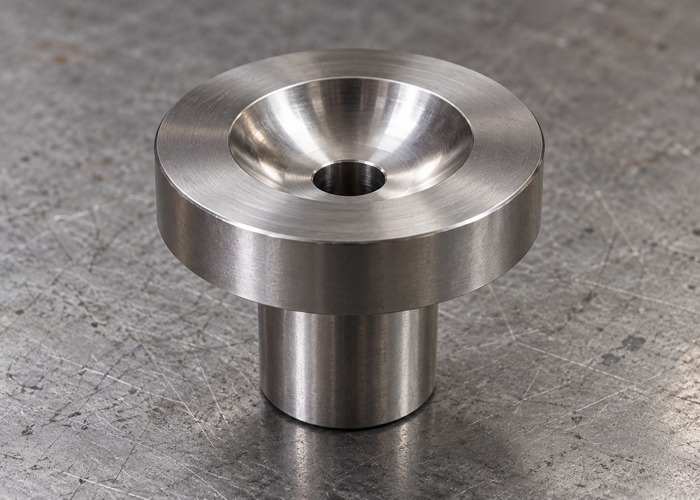 Flanged steel bushing with a concave seat and central bore