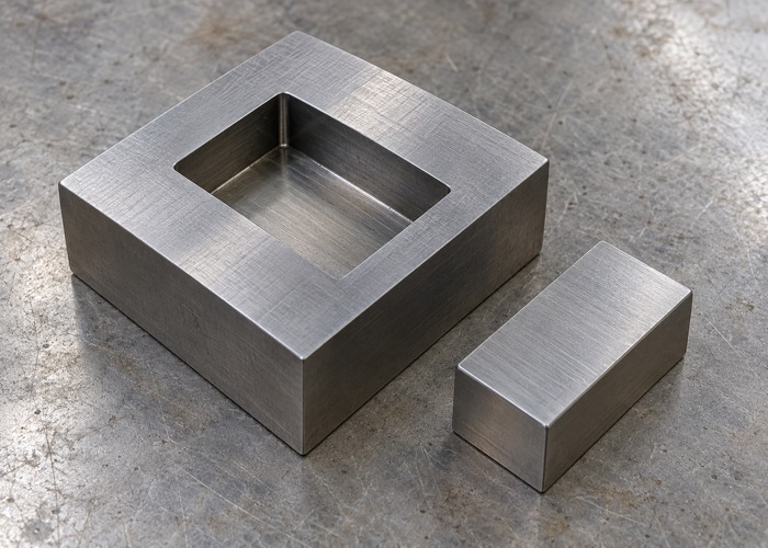 Steel receiving pocket beside a separate rectangular block