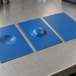 Blue coated sheet coupons with flat and deformed surfaces